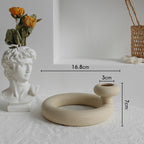 Ceramic vase shaped like a bust and a circular beige vase with measurements on a light gray background