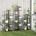 Set of plant stands with potted plants against a wooden wall.