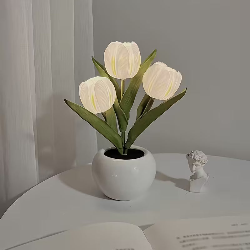 White tulip lamp on white surface with a gray curtain in the background