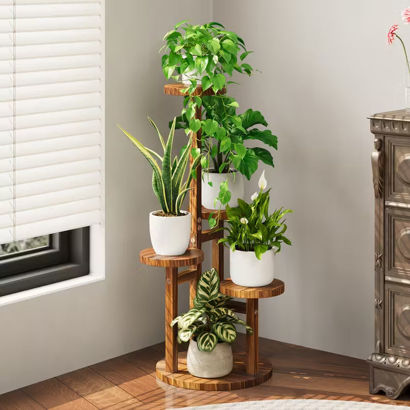 Wooden plant stand with potted plants in a room with a window and decorative cabinet.