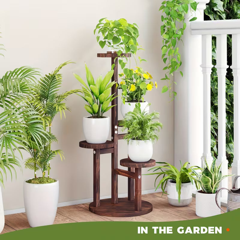 Wooden plant stand with potted plants against a neutral wall.