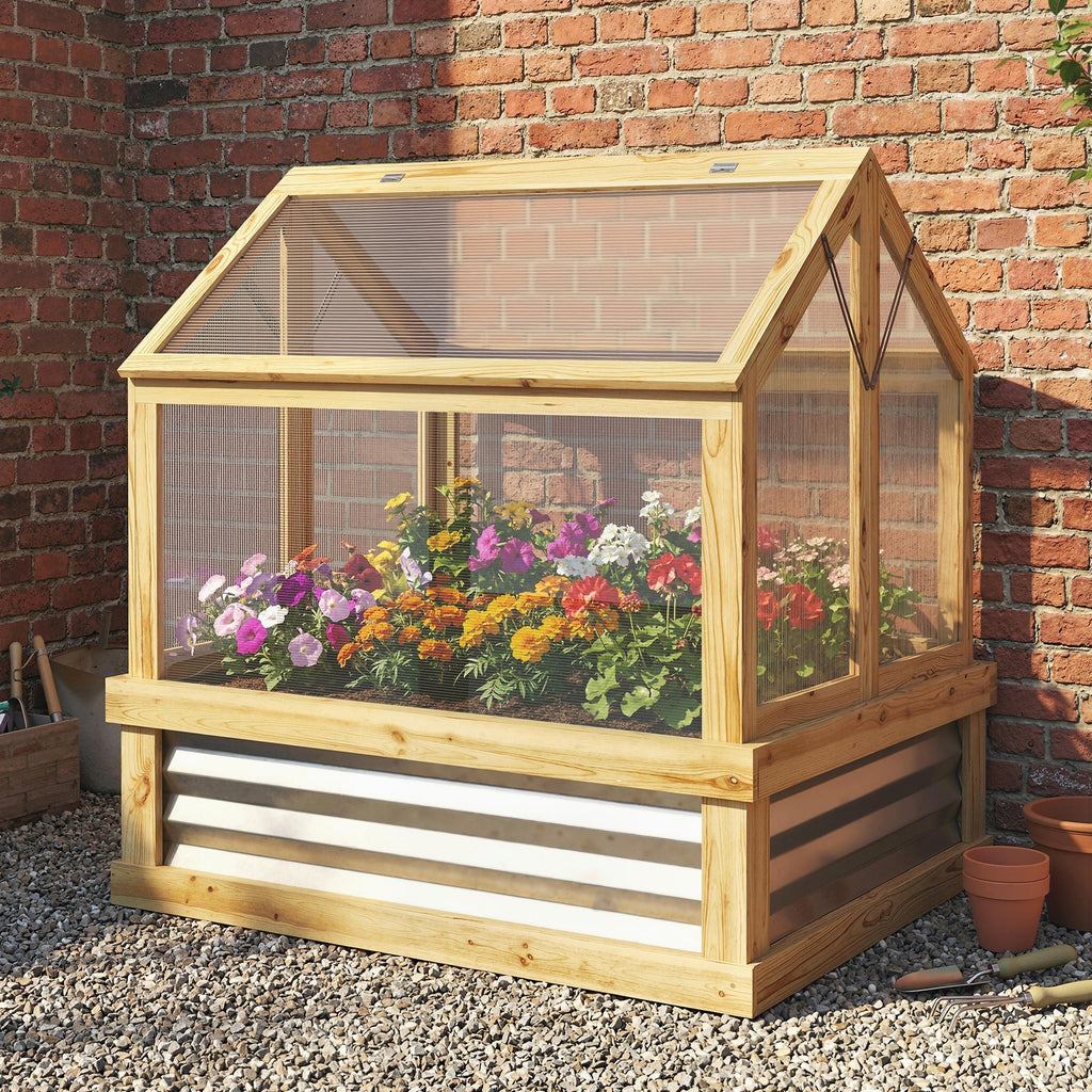 Wooden greenhouse with plants against a brick wall