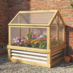 Wooden greenhouse with plants against a brick wall