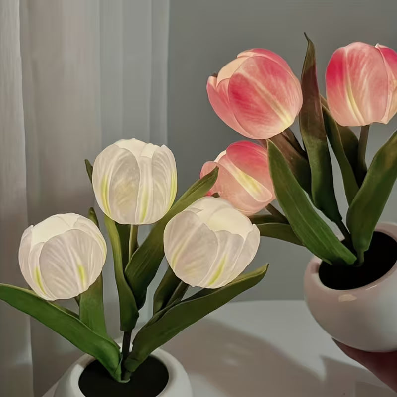 Two potted plant night lamps with white and pink flowers on a neutral background