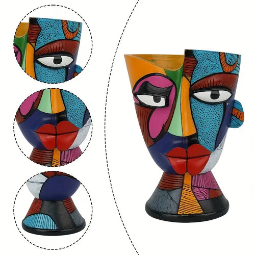 Colorful ceramic vase with face design, showing close-up details on a white background.