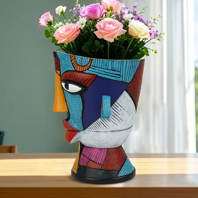 Colorful abstract vase with flowers on a wooden surface