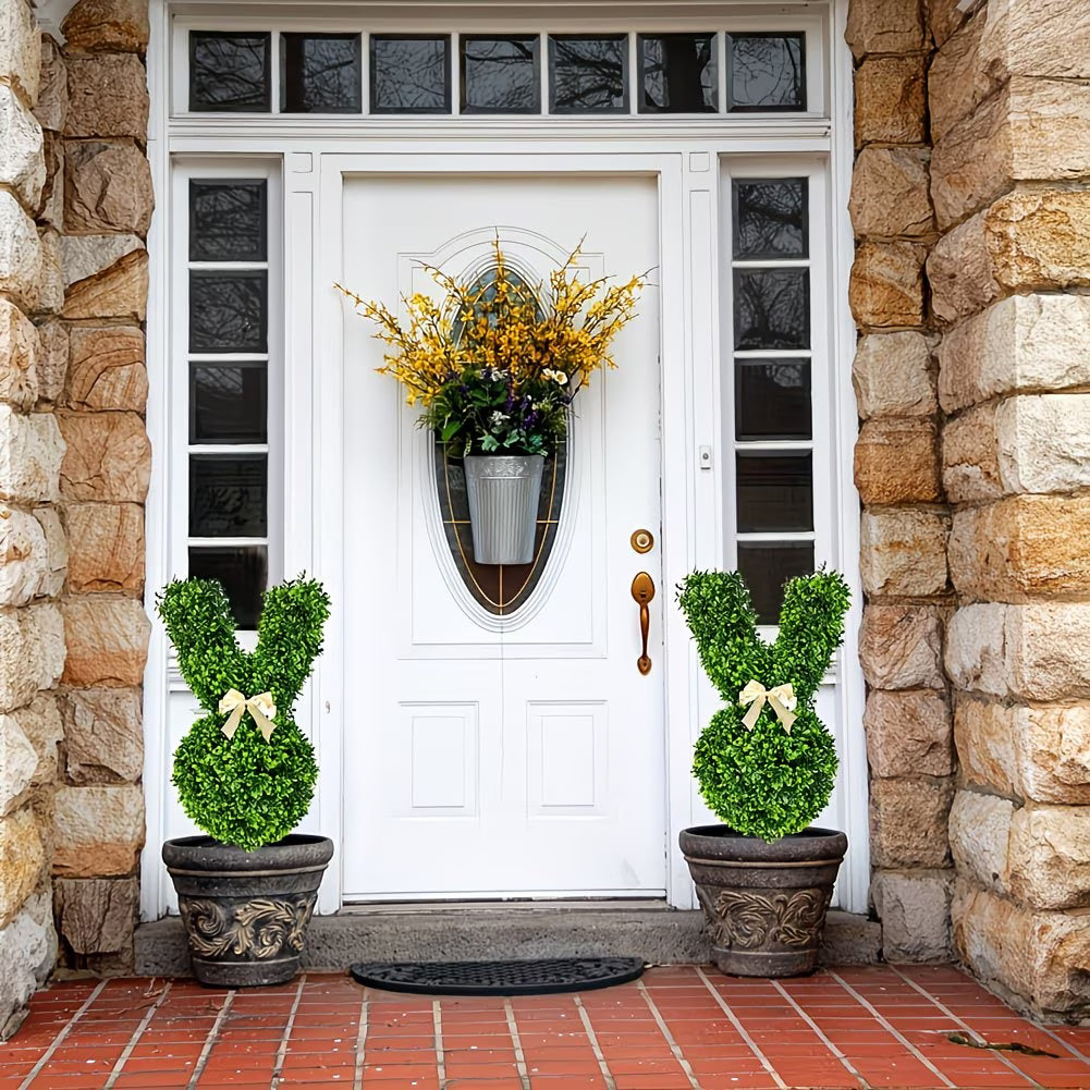 White front door with decorative plants on a stone porch