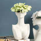 White ceramic bust with green hydrangeas on a blue background