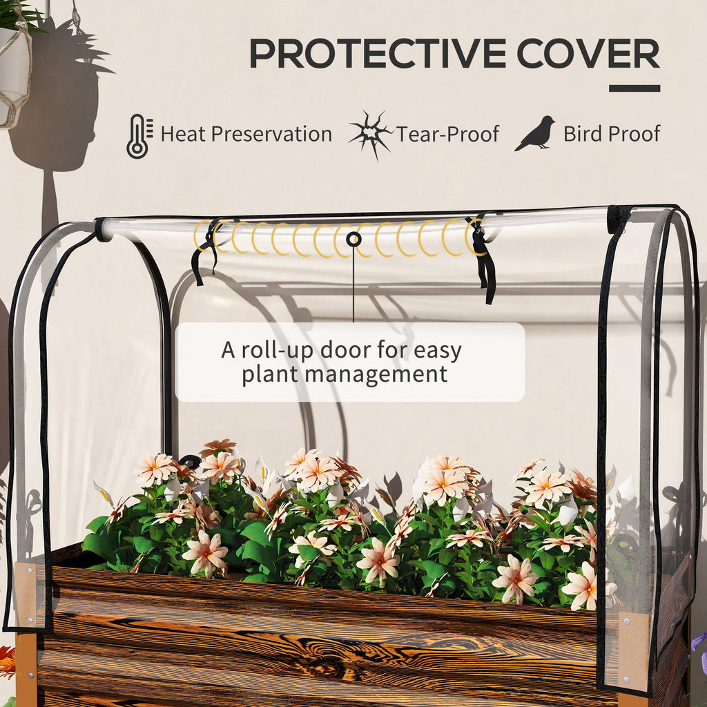 Small greenhouse with plants inside, featuring a roll-up door for easy plant management.