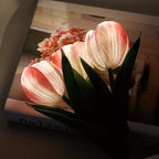 Bouquet of pink tulips on a book with a blurred background