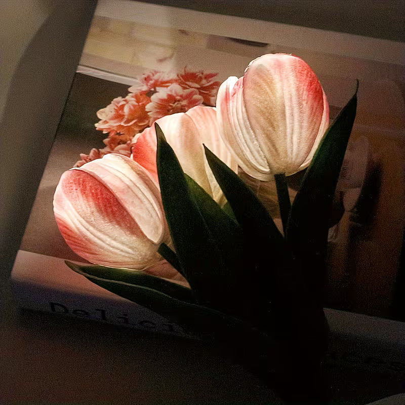 Bouquet of pink tulips on a book with a blurred background