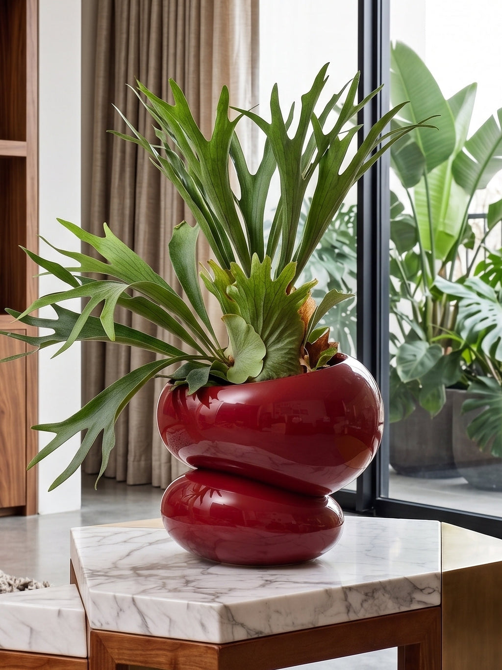 Modern living room with a marble table, wooden cabinet, and decorative plant in the fondra self watering planter. 