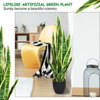 Artificial green plant in a modern living room setting with a yellow chair and decor items.
