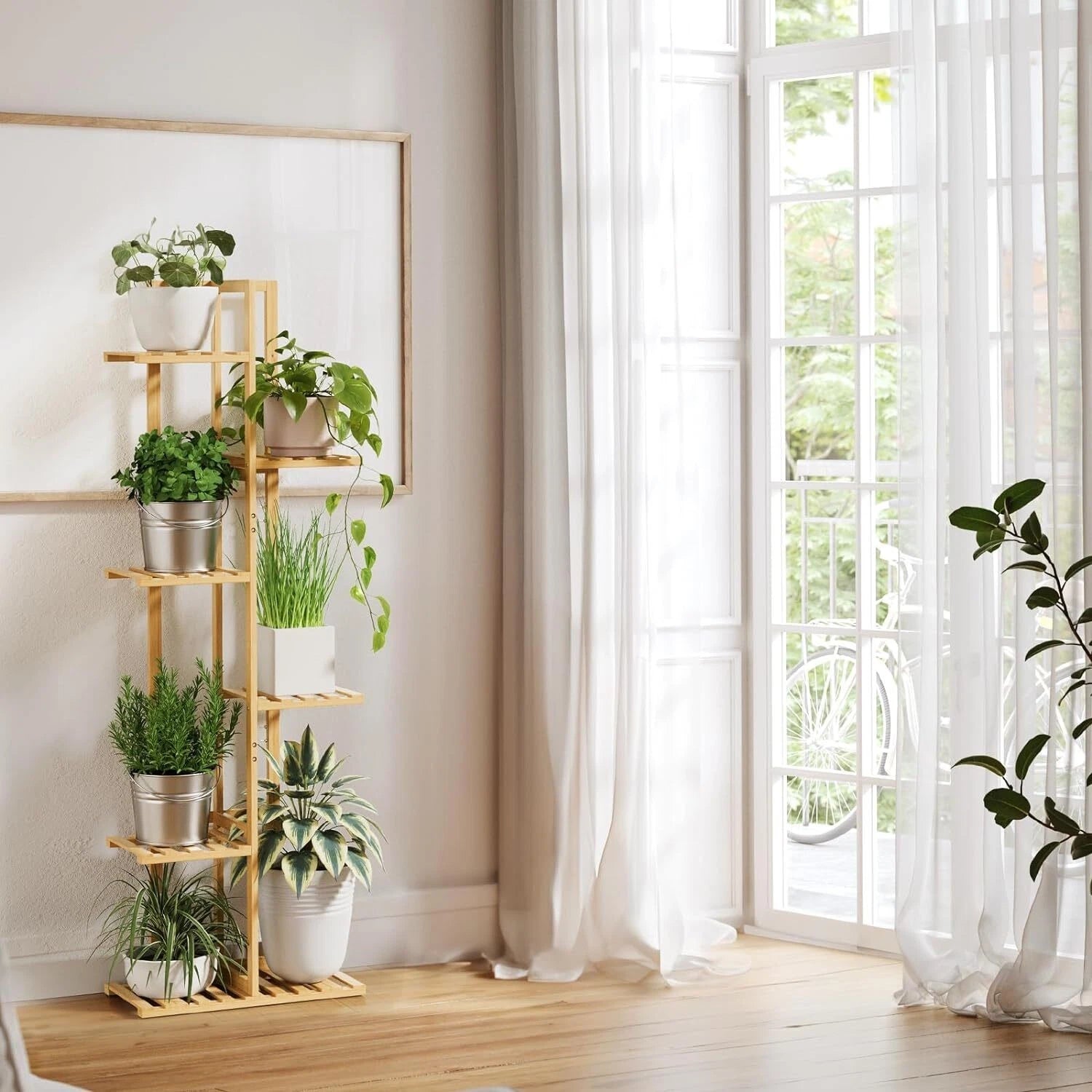 Wooden plant stand with potted plants in a bright room with large windows.